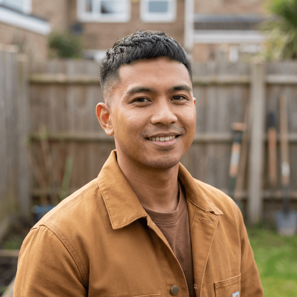 Male homeowner in his 30s standing on a wooden deck